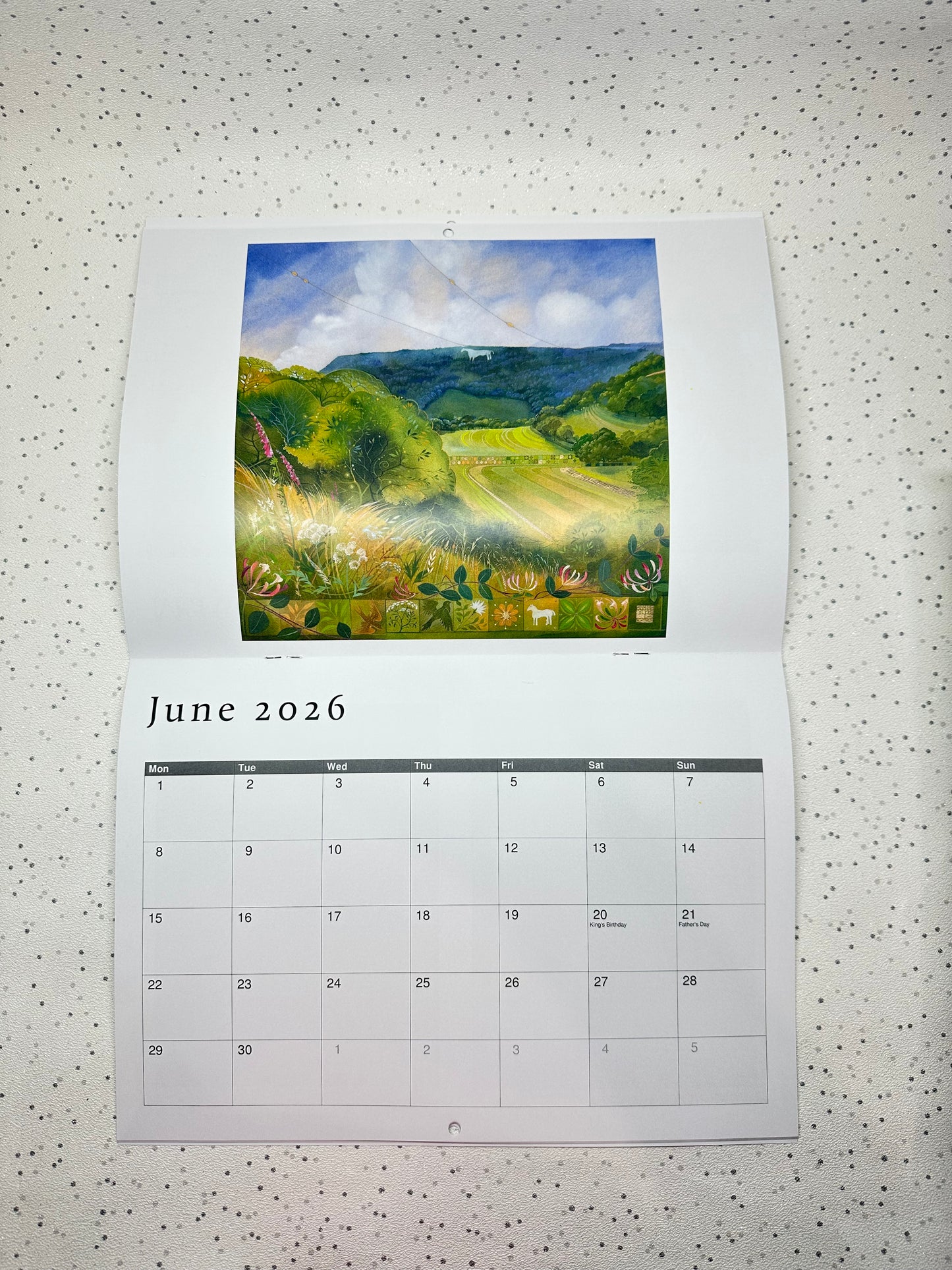 Calendar for June 2026 by Kate Lycett for Heart Gallery with a scenic landscape illustration on a speckled surface.