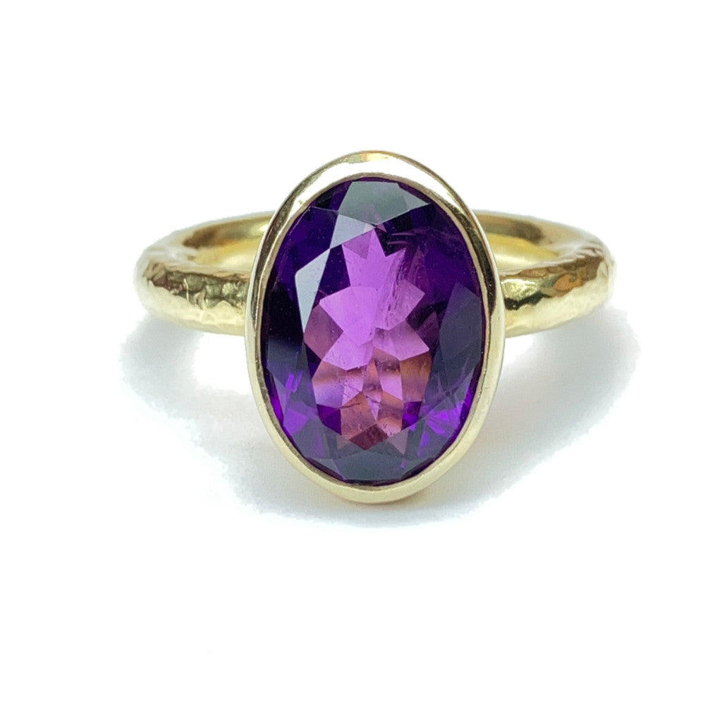 18ct Gold vermeil ring with an amethyst gemstone on a white background