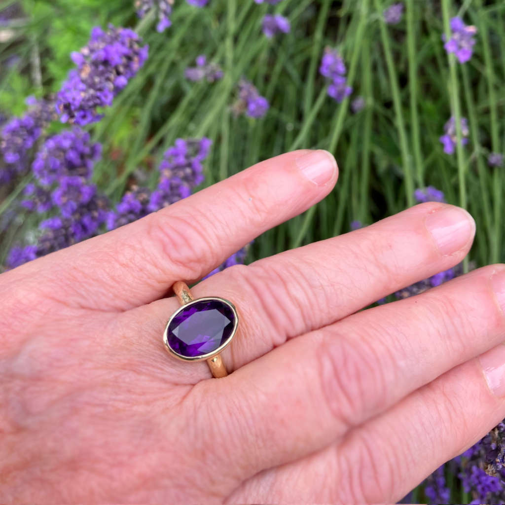Amanda Cox 18ct gold vermeil amethyst ring worn on a hand for Heart Gallery