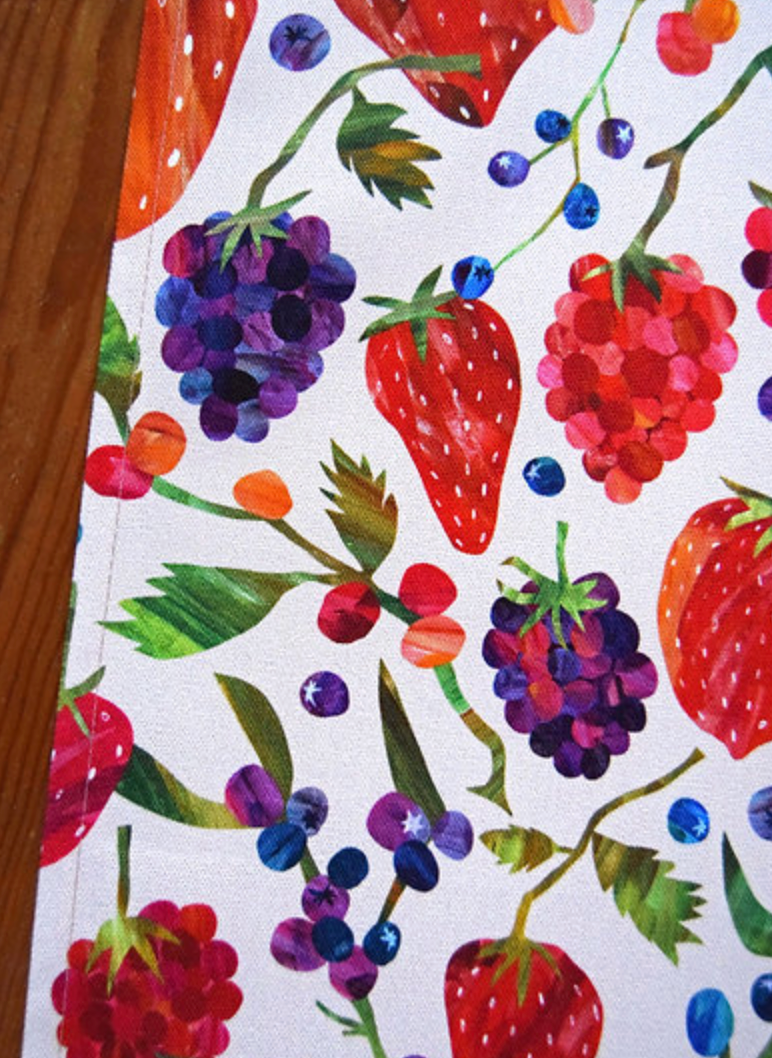 Close-up of tea towel by Freya Snow with colorful berry pattern.
