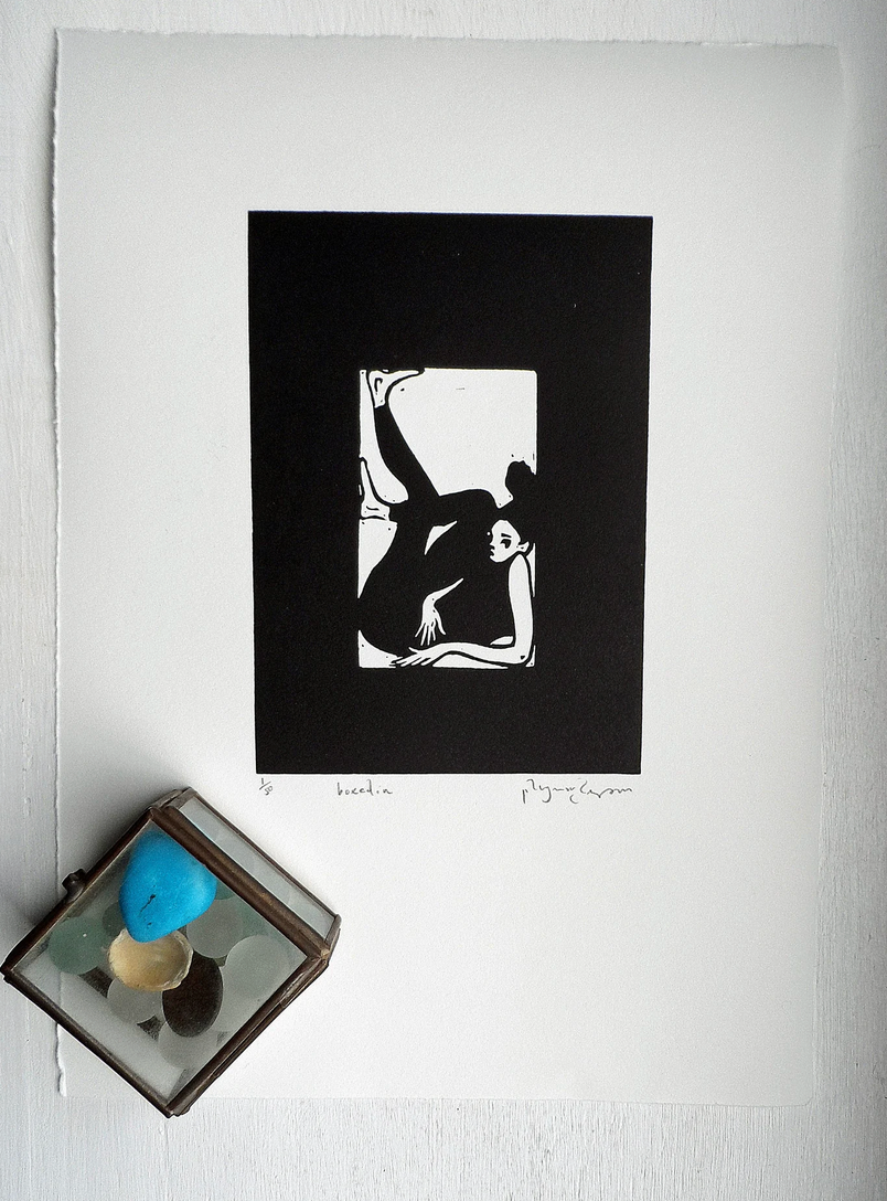 Original Linocut artwork by Polly Marix-Evans, a black and white print of a figure, titled and signed, presented on smooth white paper with a visible watermarked date. Accompanied by a colored glass object to the side.