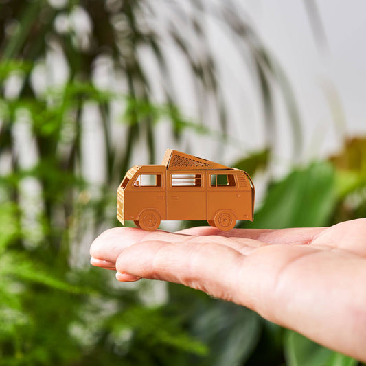 A brass miniature model of a camper van with a pop-top roof, intended for use as a terrarium or plant decoration.