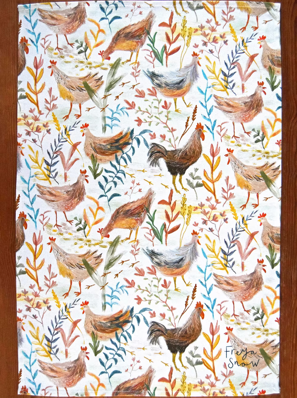 Tea towel with chicken and leaf pattern on a white background by Freya Snow
