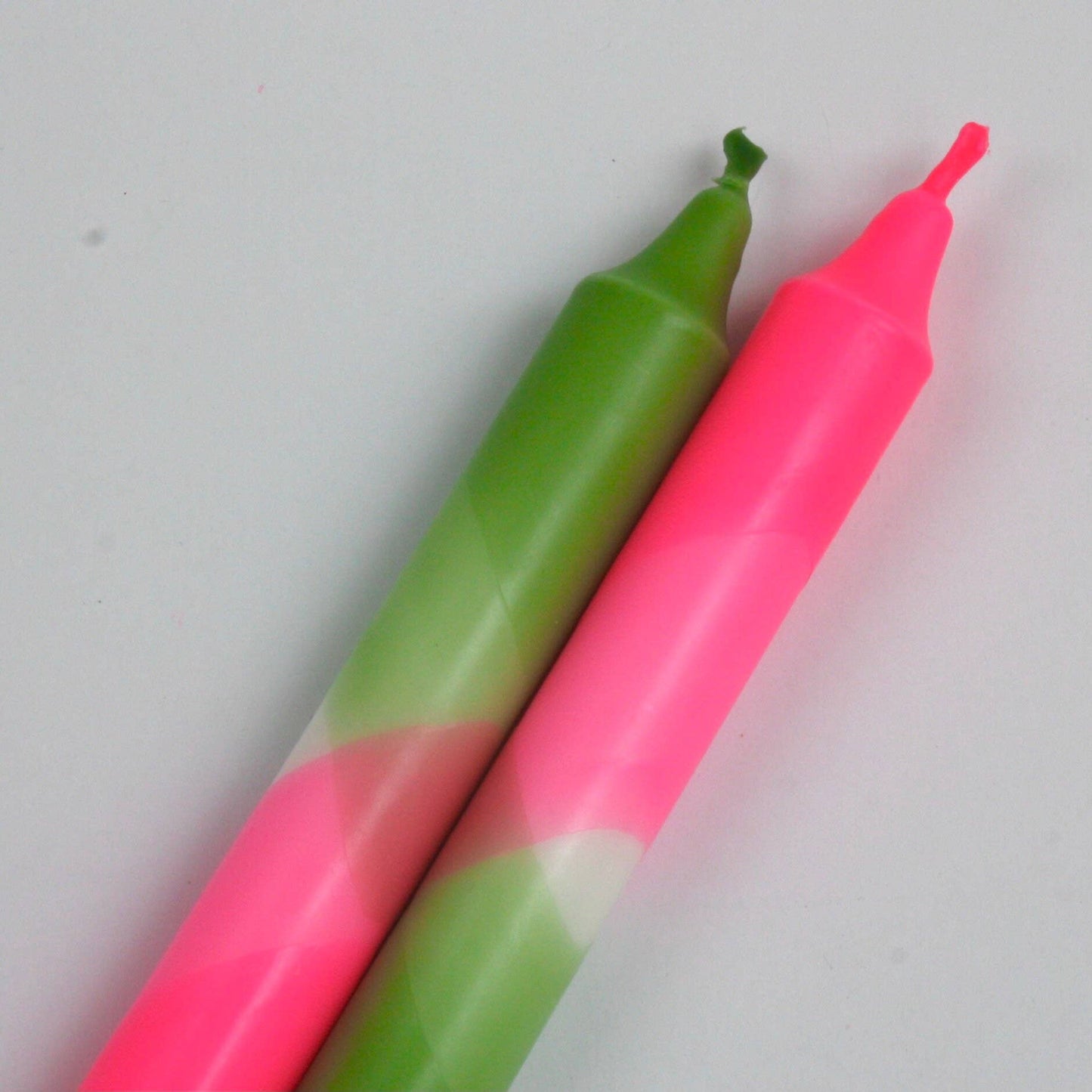 The Singing Rabbit neon pink and green pack of 2 candles hand dip dyed