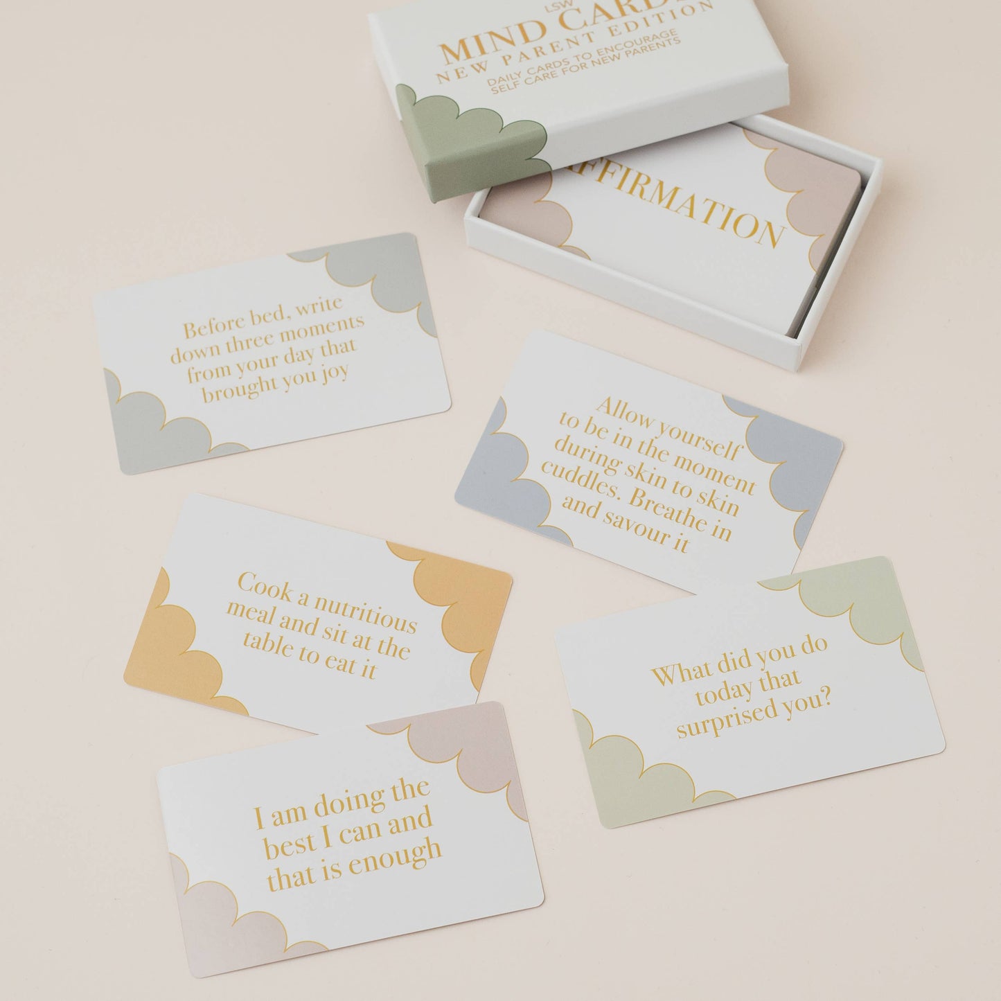 Set of cards with motivational phrases in a box on a beige background by LSW Mind Cards