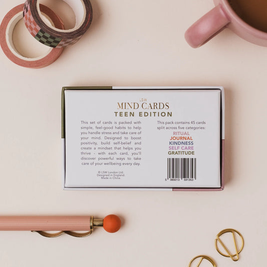 Box of 'MIND CARDS TEEN EDITION' on a light surface with stationery items.