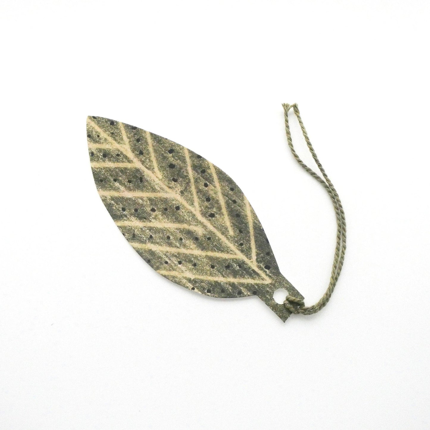 Leaf-shaped gift tag by Hadley on a white background