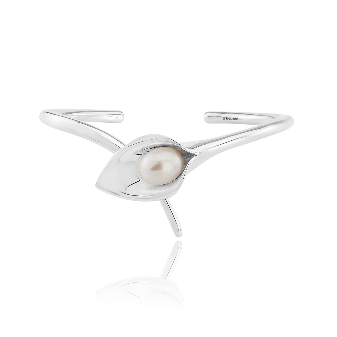 A silver bangle bracelet with a large cultured freshwater pearl, displayed against a white background.Amanda Cox, jewellery handmade in Hebden Bridge Yorkshire for Heart Gallery