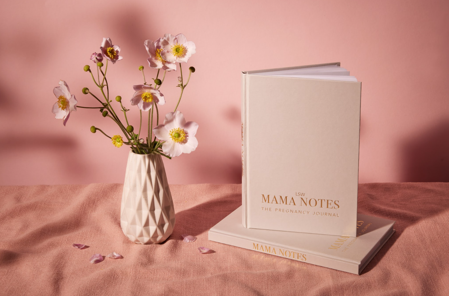 A white, undated pregnancy journal titled 'MAMA NOTES' with gold text detailing the content focus on hypnobirthing, affirmations, and gratitude. It is pictured with a label indicating it is printed and bound in the UK. LSW for Heart Gallery
