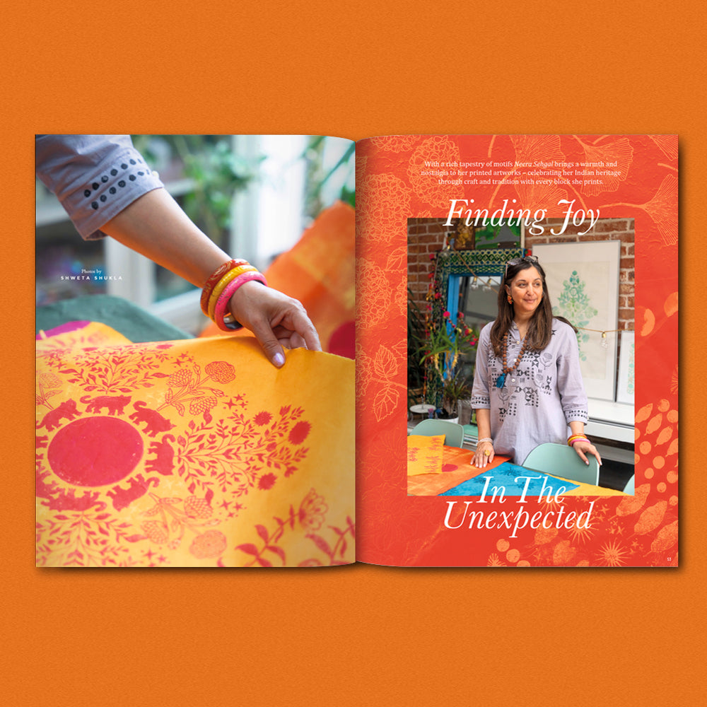 Book with a colorful cover and a photo of a woman on an orange background for Pressing Matters magazine issue 31 for Heart Gallery