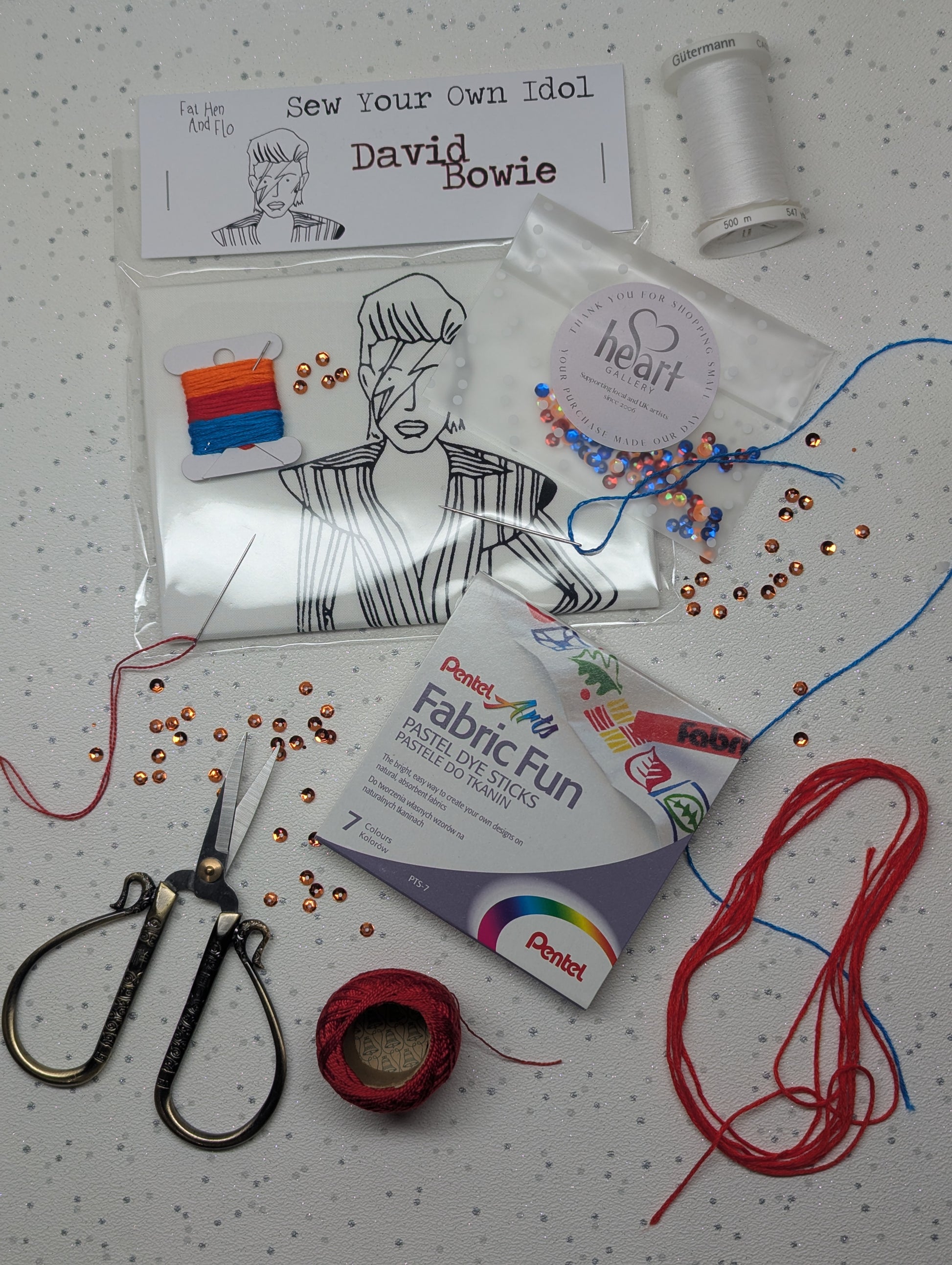 Crafting kit with sewing supplies with a sew your own David Bowie on a speckled surface. crafty fun for all ages