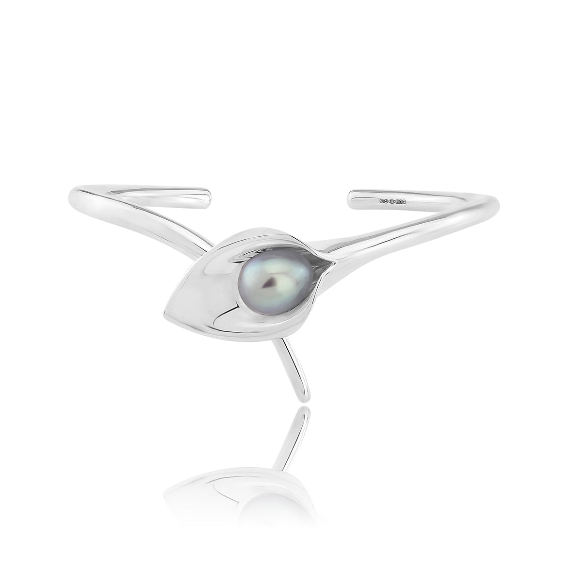 A silver bangle bracelet with a large cultured freshwater pearl, displayed against a white background.Amanda Cox, jewellery handmade in Hebden Bridge Yorkshire for Heart Gallery