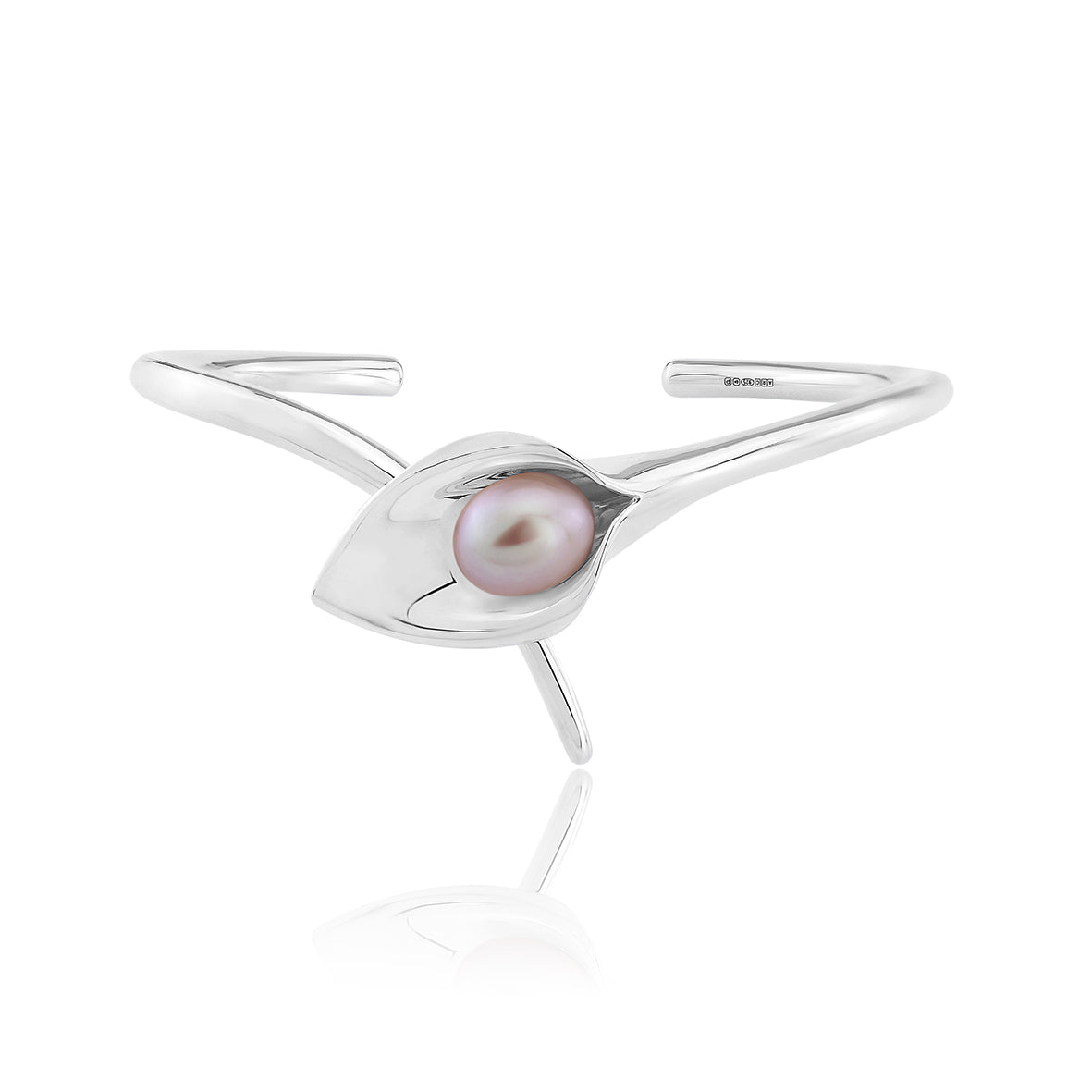 A silver bangle bracelet with a large cultured freshwater pearl, displayed against a white background.Amanda Cox, jewellery handmade in Hebden Bridge Yorkshire for Heart Gallery