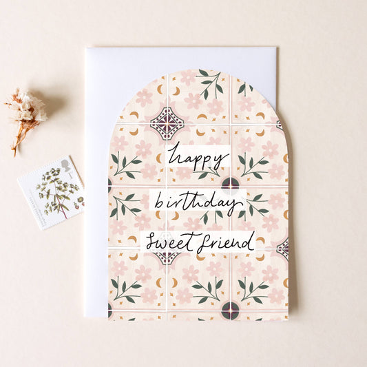 Floral-patterned card with 'Happy birthday, sweet friend' text on a beige background