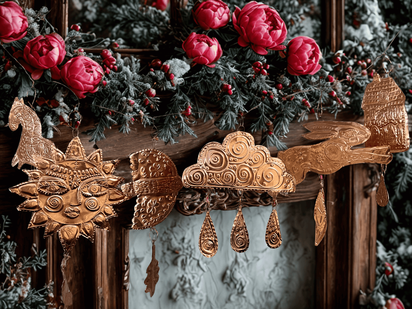Decorative mantel with copper garland ornaments and red flowers. The Makers' Table - A Garland Gathering at Heart Gallery