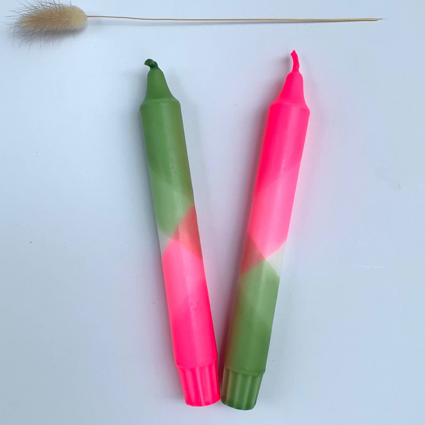 Two gradient candles, one green to pink and the other pink to green, on a white background by The Singing Rabbit