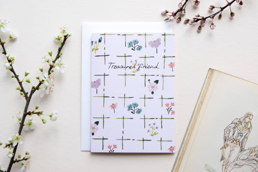 greetings card with floral design and 'Trusted Friend' text on a light background with decorative elements.