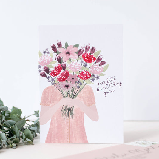 Greeting card with floral design and text 'For the birthday girl' on a white background.