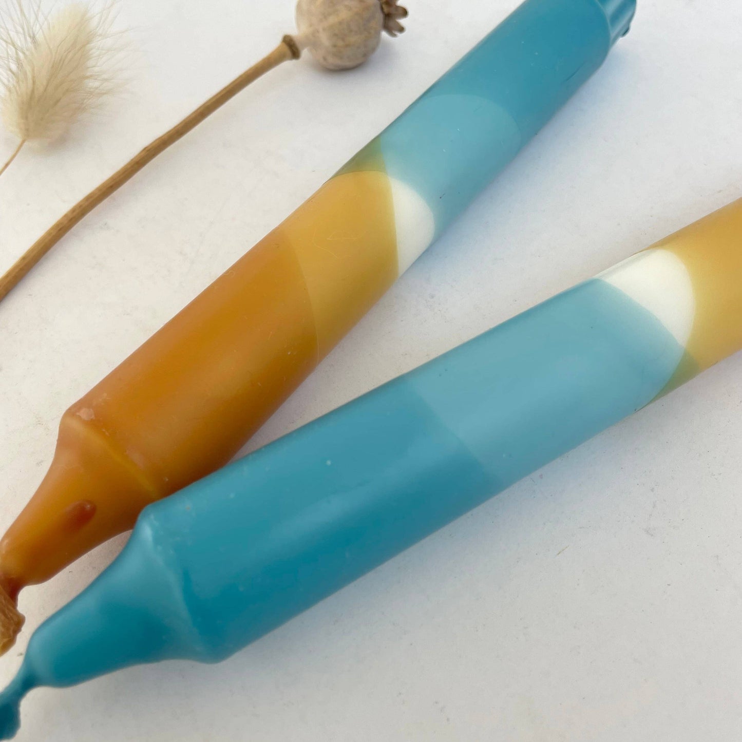 Two colorful hand dip dyed candles by The Singing Rabbit - close up image