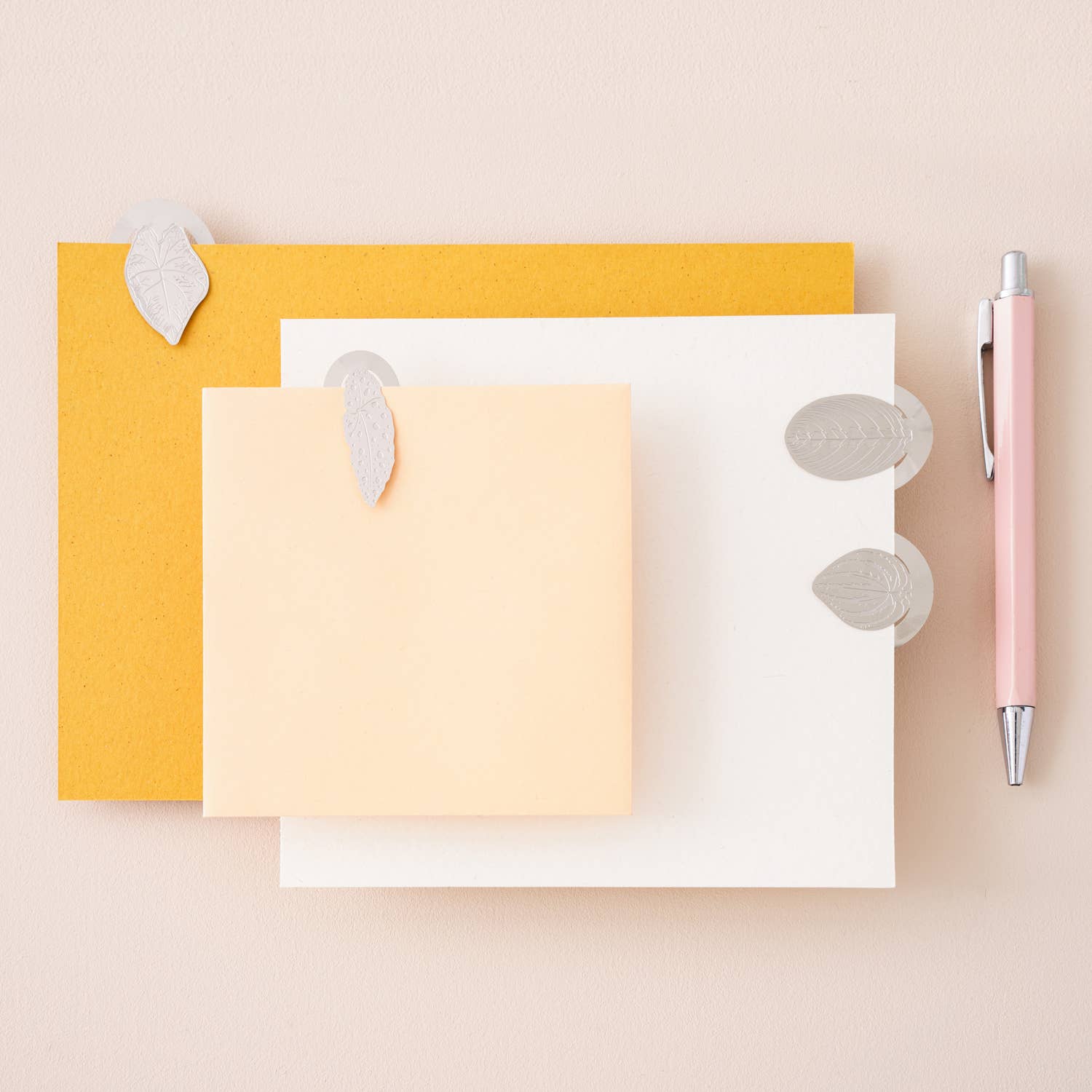 A set of stainless steel leaf bookmarks featuring four unique leaves, styled by Another Studio for Heart Gallery