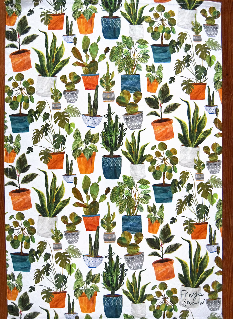 Tea towel by Freya Snow with potted plants on a white background