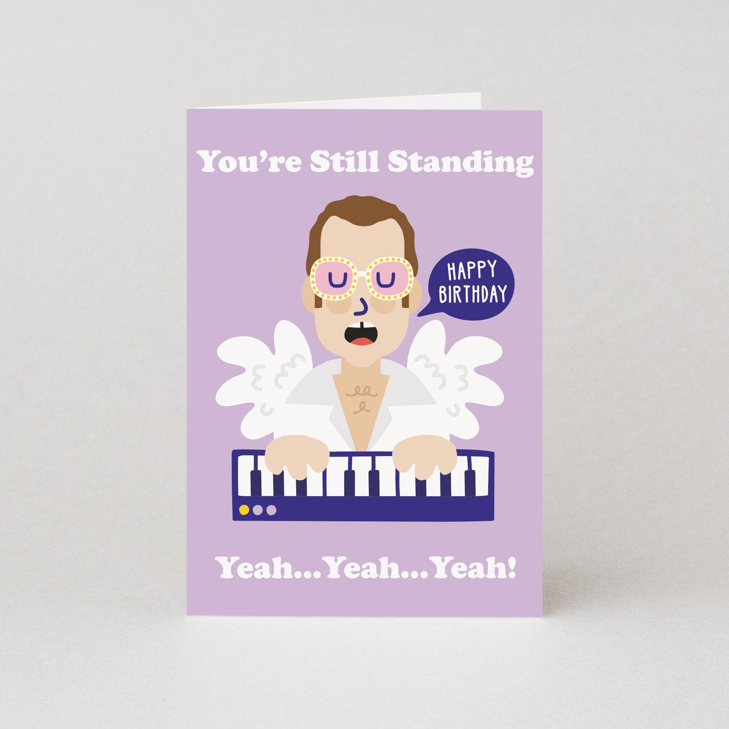 Birthday card with a cartoon character Elton Johnplaying keyboard and text on a purple background
