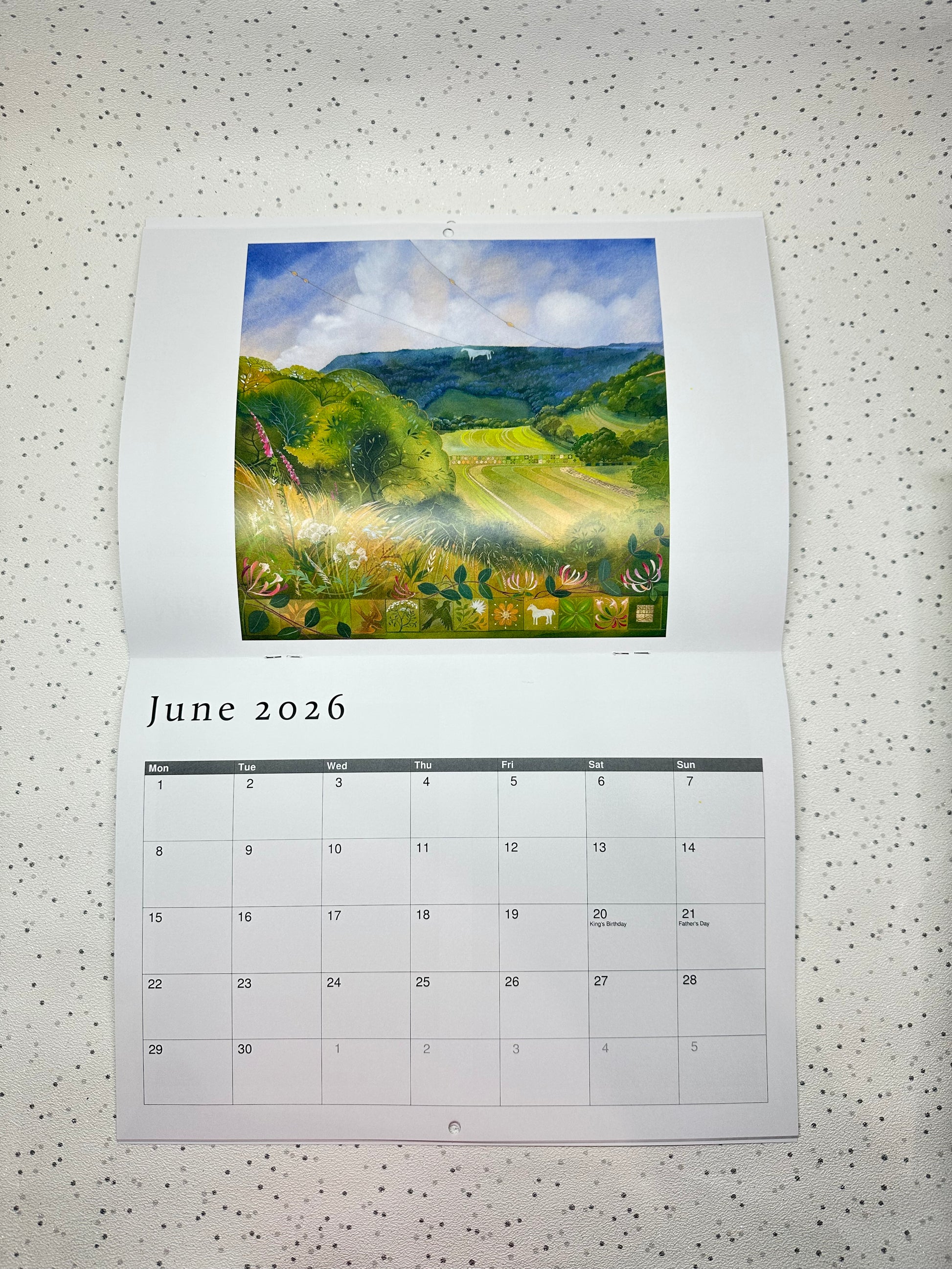 Calendar for June 2026 by Kate Lycett for Heart Gallery with a scenic landscape illustration on a speckled surface.
