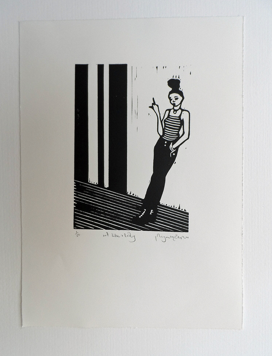 A black and white linocut artwork of a female figure  with a bun standing on one foot, with a pointing finger, titled and signed by Polly Marix-Evans.