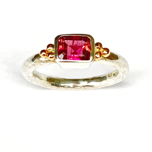 silver ring with a pink tourmline gemstone and 9ct gold granules on a white background. October birthstone Amanda Cox for Heart Gallery
