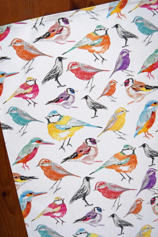 Tea Towel Colorful pattern of various birds on a white background.