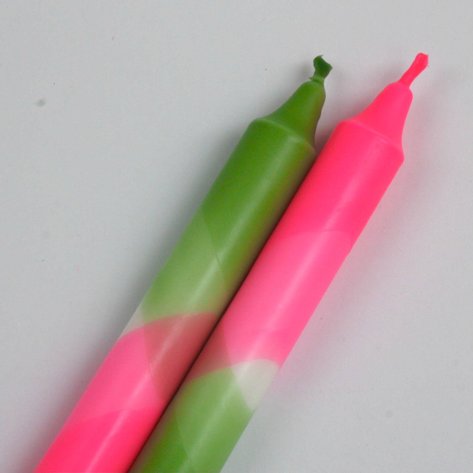 The Singing Rabbit neon pink and green pack of 2 candles hand dip dyed