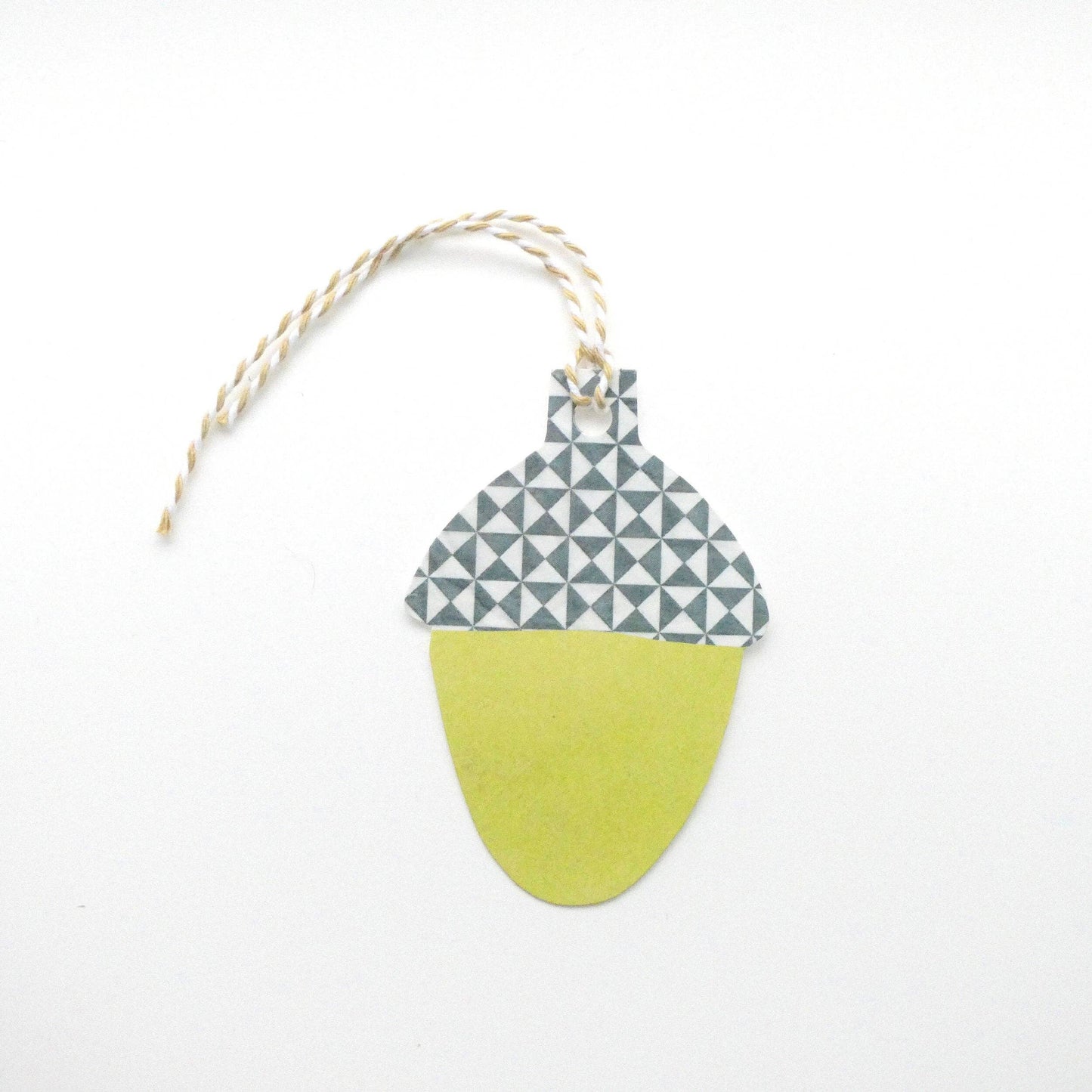 Decorative acorn gift tag with geometric pattern on a white background