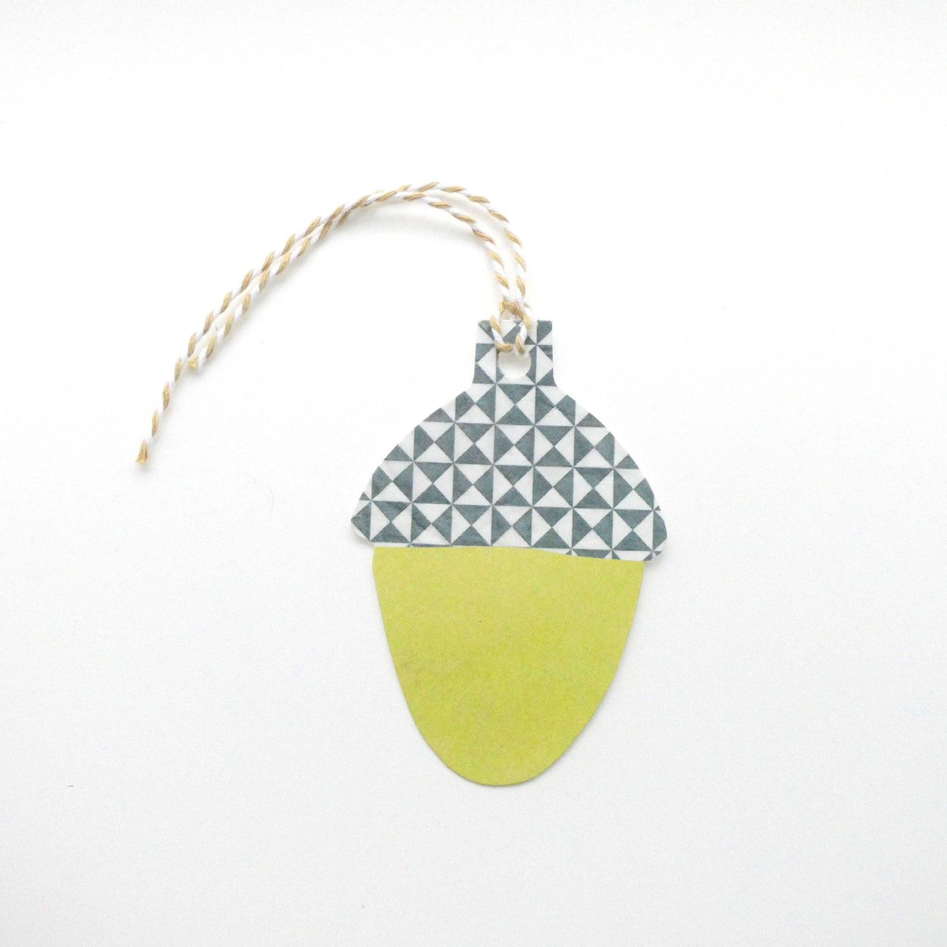Decorative acorn gift tag with geometric pattern on a white background