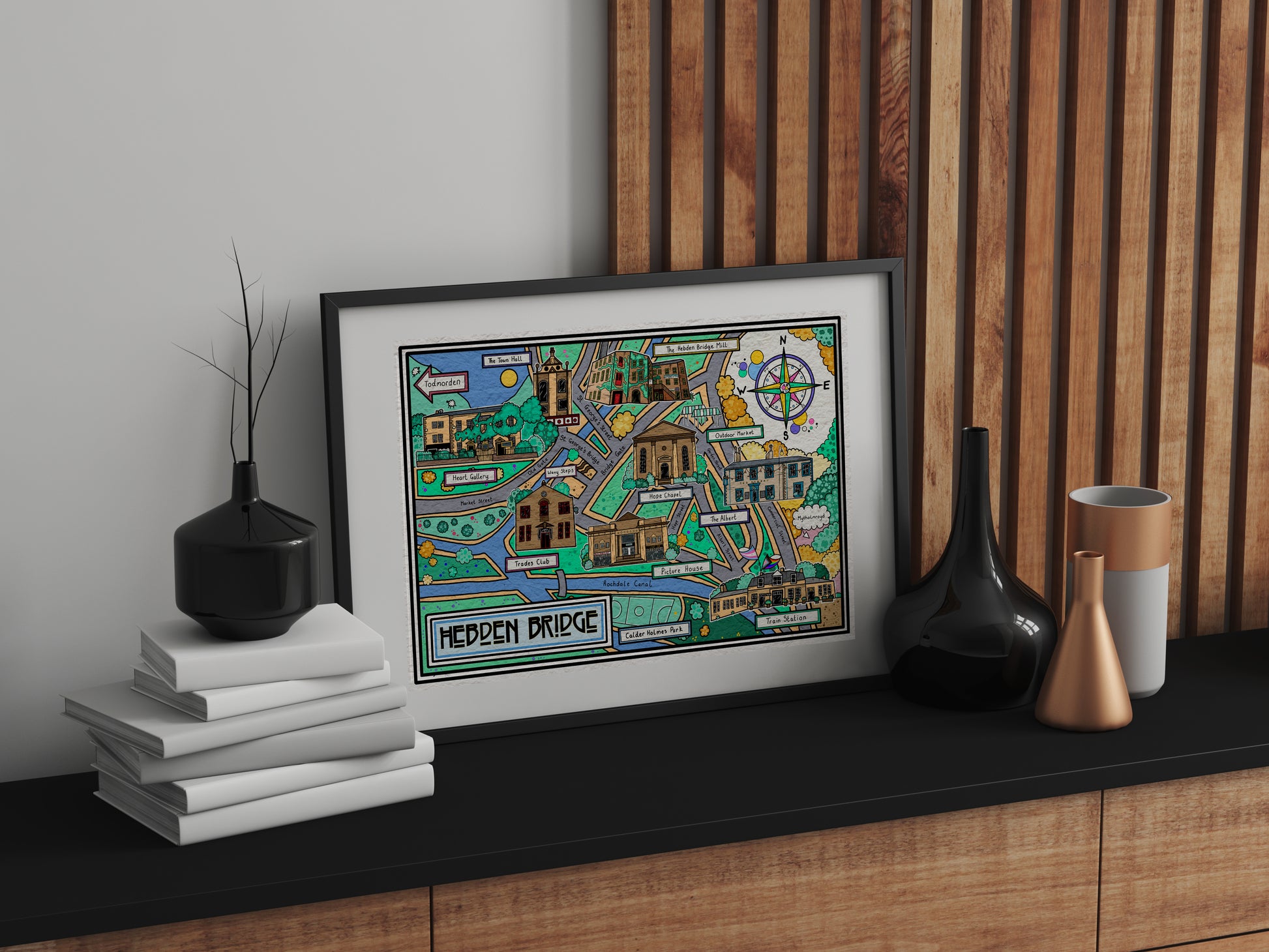 Framed map print by Lucy Parker for Heart Gallery on a shelf with decorative items