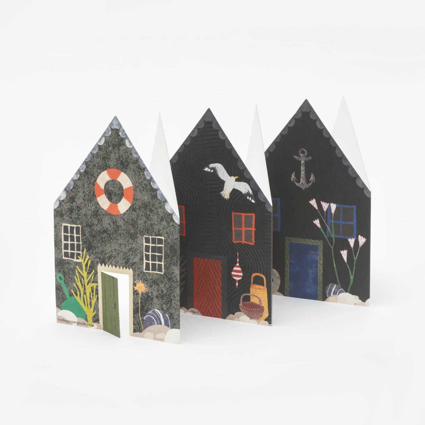  decorative paper houses with various designs on a white background