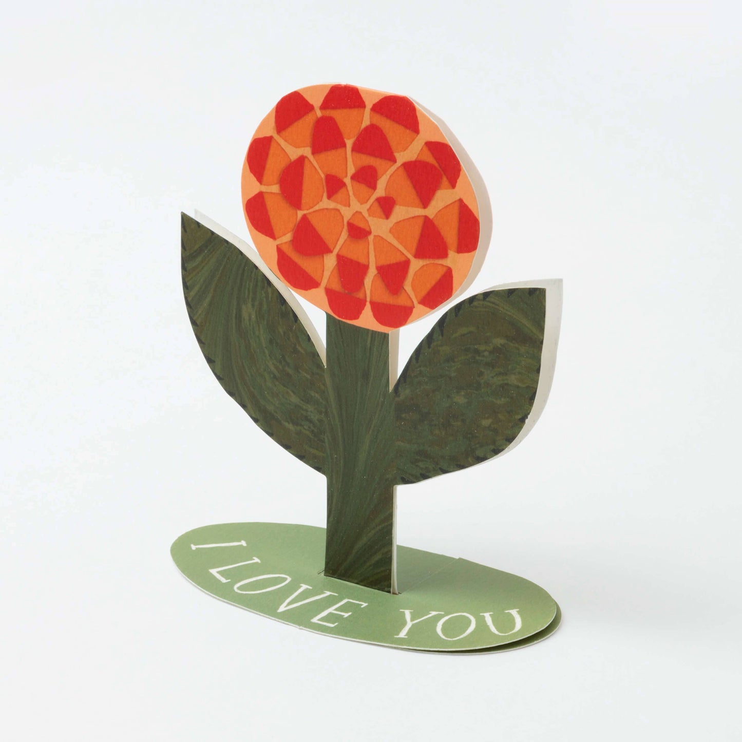 Decorative flower with red petals and green leaves on a white background