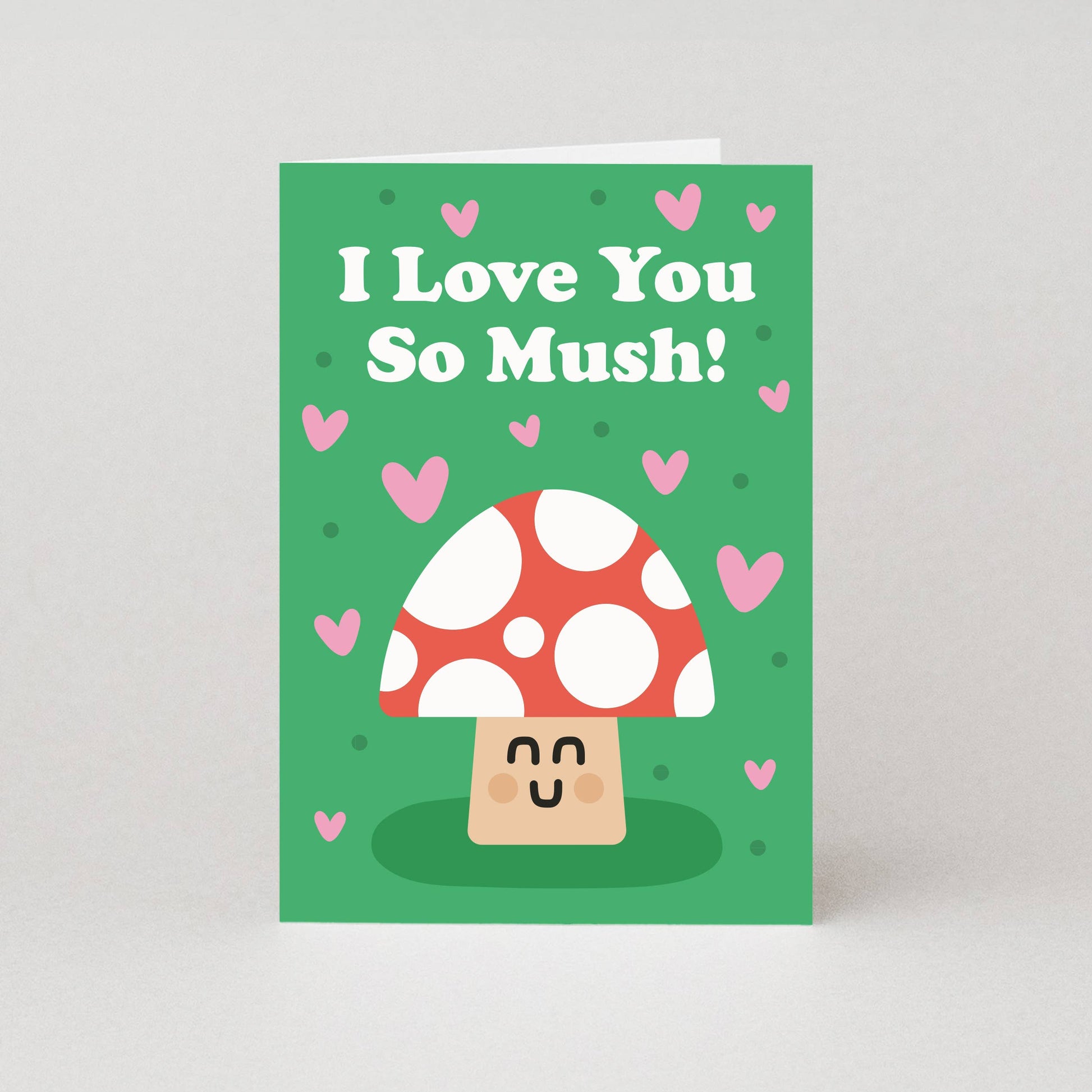 Card with a mushroom design and text 'I Love You So Mush!' on a green background with pink hearts.