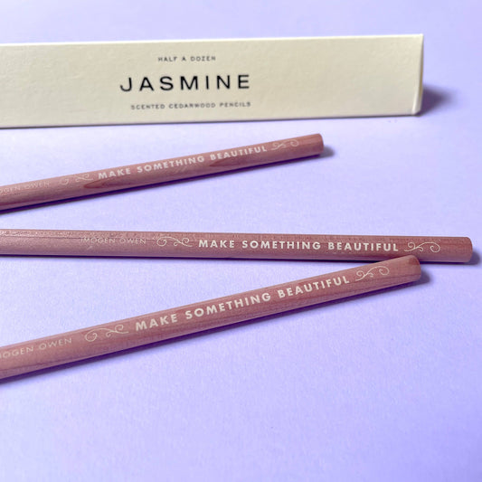 half a dozen scented cedarwood pencils with 'Make Something Beautiful' text on a purple background, accompanied by a letterpress box labeled 'Jasmine'  by Imogen Owen for Heart Gallery