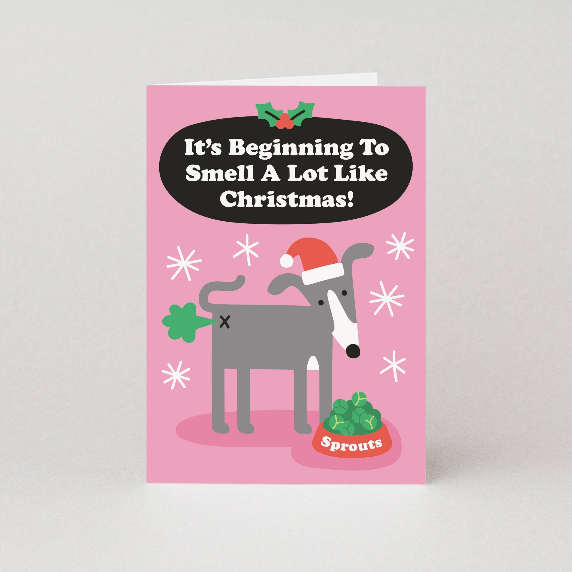 Pink Christmas card with a dog illustration and text on a white background