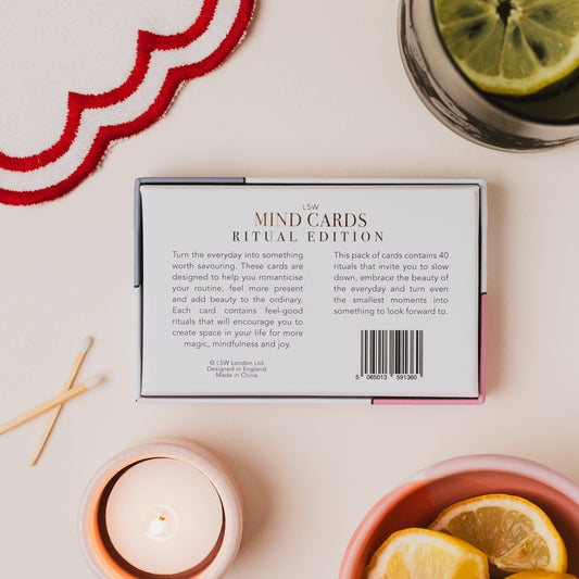 Mind cards packaging with a candle, lemons, and matches on a table