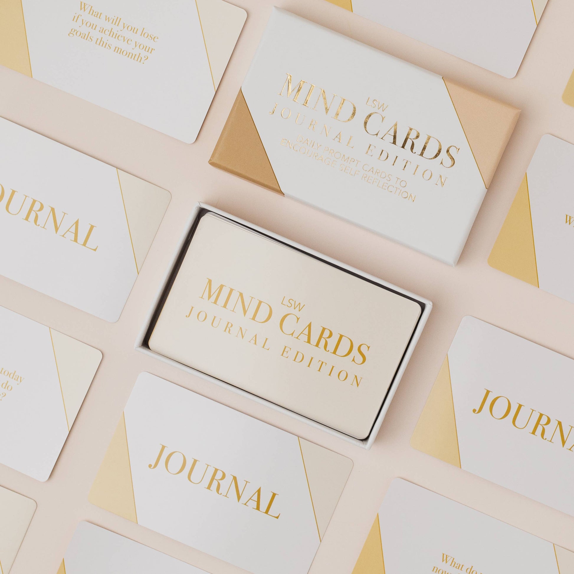 Set of 'Mind Cards' journal edition packaging on a beige background