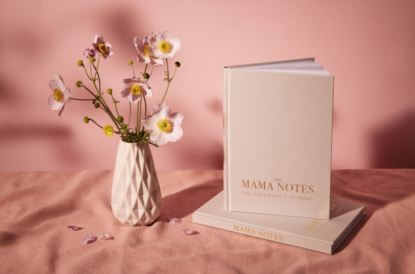 A white, undated pregnancy journal titled 'MAMA NOTES' with gold text detailing the content focus on hypnobirthing, affirmations, and gratitude. It is pictured with a label indicating it is printed and bound in the UK. LSW for Heart Gallery