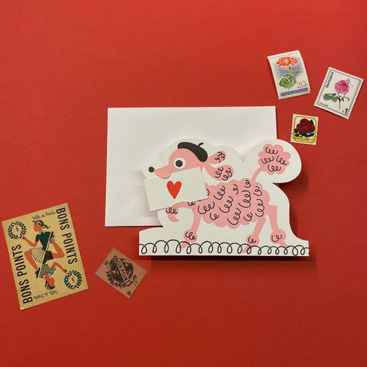 Card with a pink poodle holding a heart, envelope, and vintage-style stamps on a red background