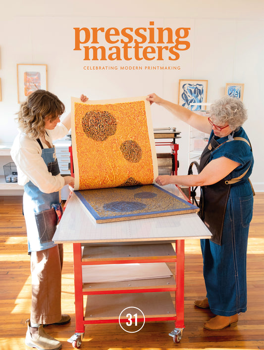 Two people working with printmaking materials in a studio setting, with 'pressing matters' text above. Pressing Matters magazine celebrating modern printmaking
