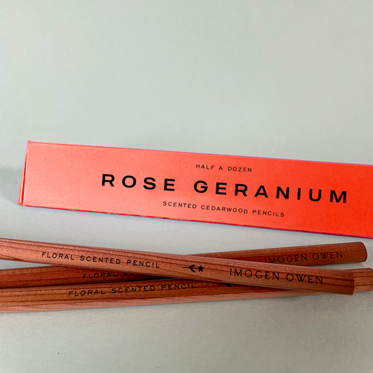 Rose Geranium scented cedarwood pencils with packaging on a light gray background by Imogen Owen