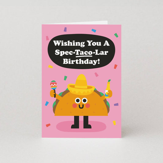 Birthday card with a cartoon taco character and humorous birthday message on a pink background