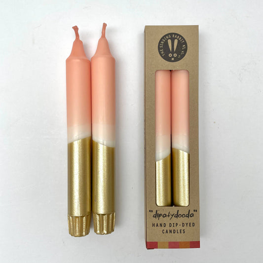 Two dinner candles with a blush pink and gold color scheme packed in eco packaging by The Singing Rabbit for Heart Gallery