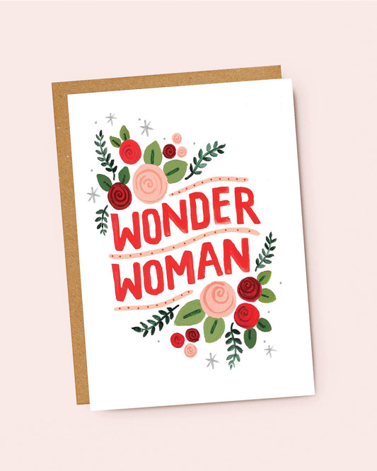 Greeting card with 'Wonder Woman' text and floral design on a pink background by Jade Fisher