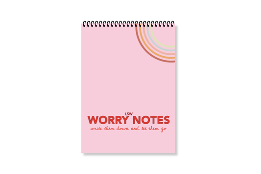 A white, wire-bound notebook with a pink cover featuring the title 'Worry Notes' in red text, along with a small decorative element on the top  right by LSW for Heart Gallery