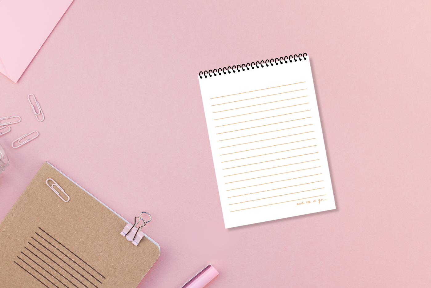 A white lined paper, wire-bound notebook with a pink cover featuring the title 'Worry Notes' in red text, along with a small decorative element on the top  right by LSW for Heart Gallery